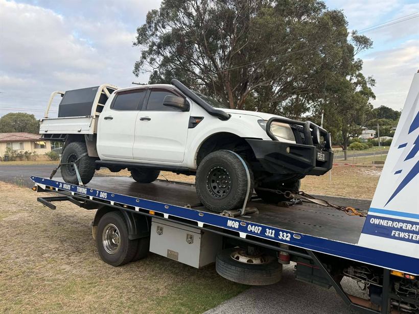 White Ford Ranger ute on the tilt tray