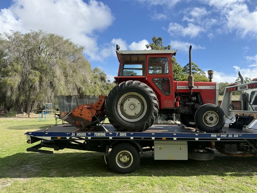 Tractor with slasher attachment on the tilt tray