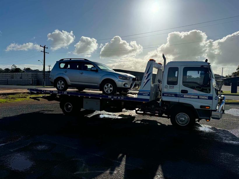 SUV on the tilt tray with the morning sun behind
